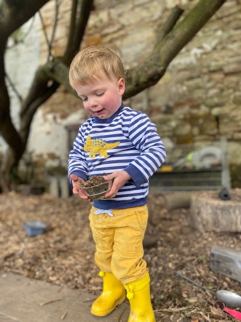 Making Cakes in the mud kitchen